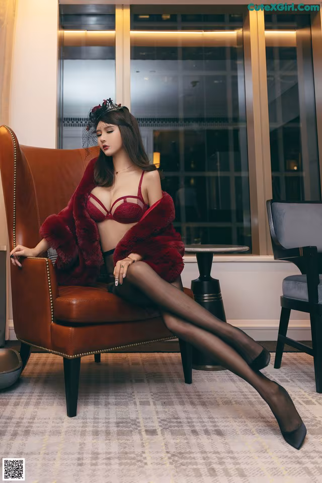 A woman sitting on a brown chair in a room.