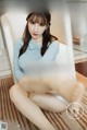 a woman sitting on top of a white chair